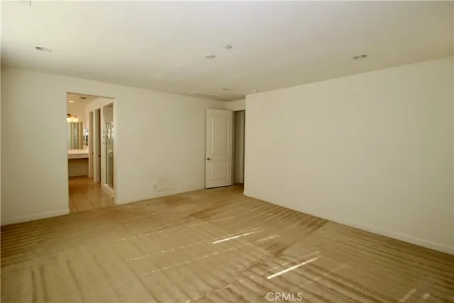 a spacious bathroom with a bathtub sink and mirror