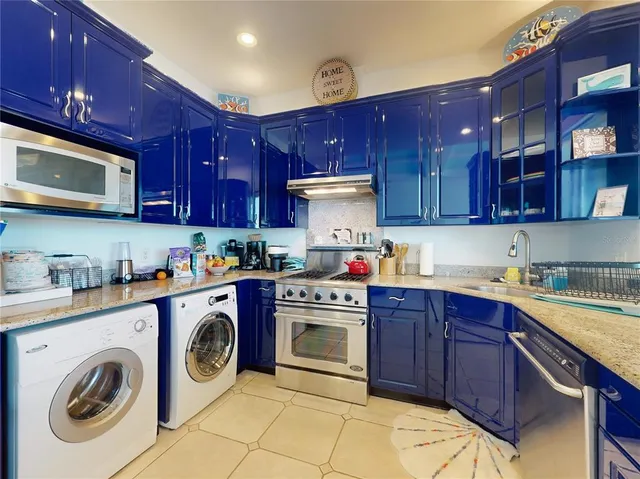 a kitchen with wooden cabinets and stove top oven