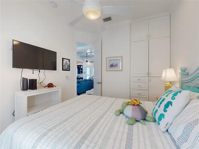 a bedroom with a bed and a flat screen tv