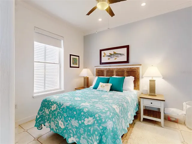 a bedroom with a bed and a painting on the wall