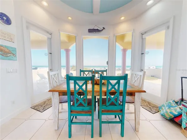 a dining room filled chandelier and kitchen view