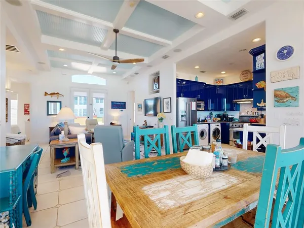 a living room with lots of furniture and kitchen view
