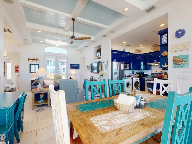 a living room with lots of furniture and kitchen view