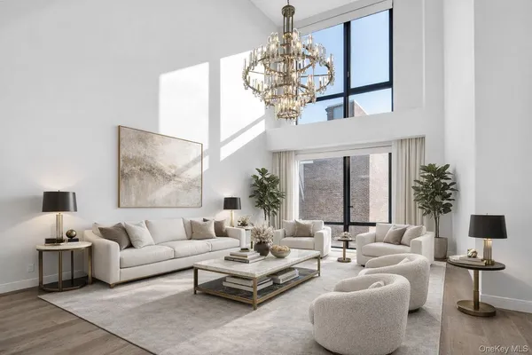 a living room with furniture and a chandelier
