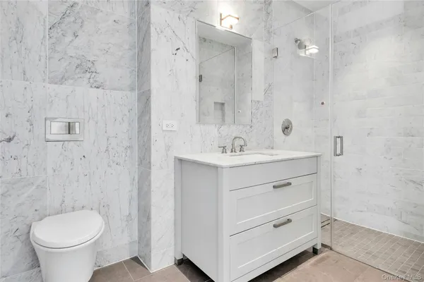 a bathroom with a double vanity sink toilet and a mirror