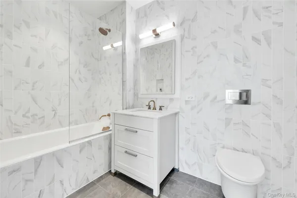 a bathroom with a sink a toilet and bathtub