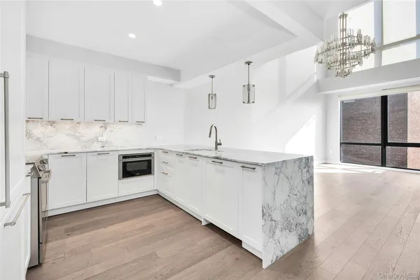 a kitchen with a sink cabinets and window