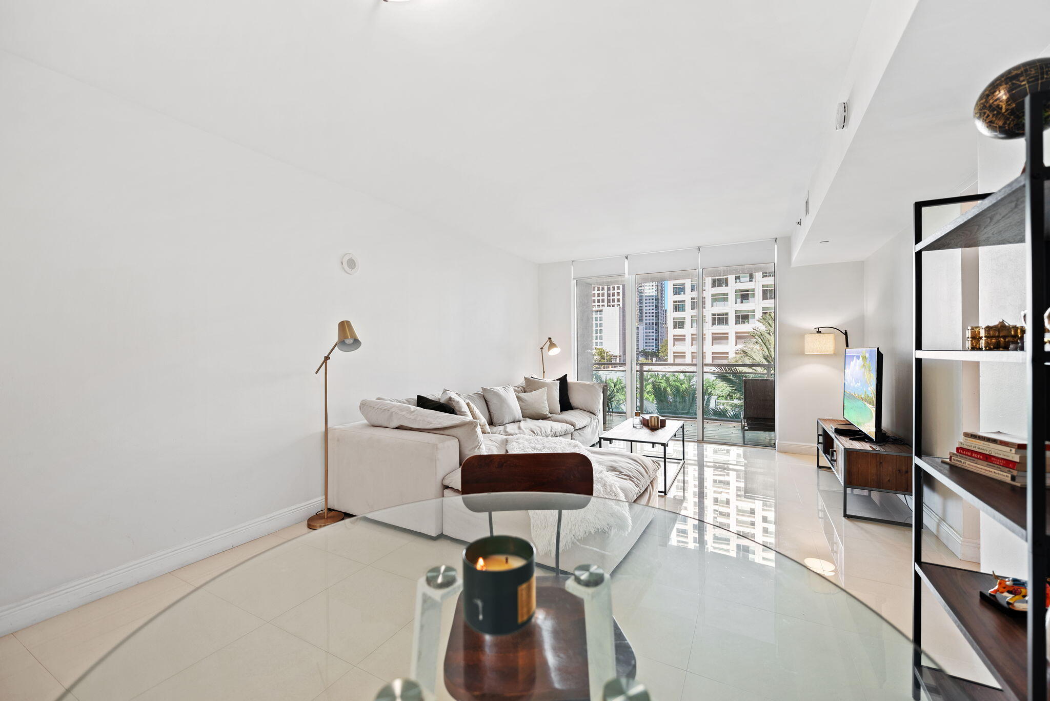 951 Brickell Avenue, Unit 400 Miami, FL 33131 - Photo 15 of 40 a living room with furniture a flat screen tv and a floor to ceiling window