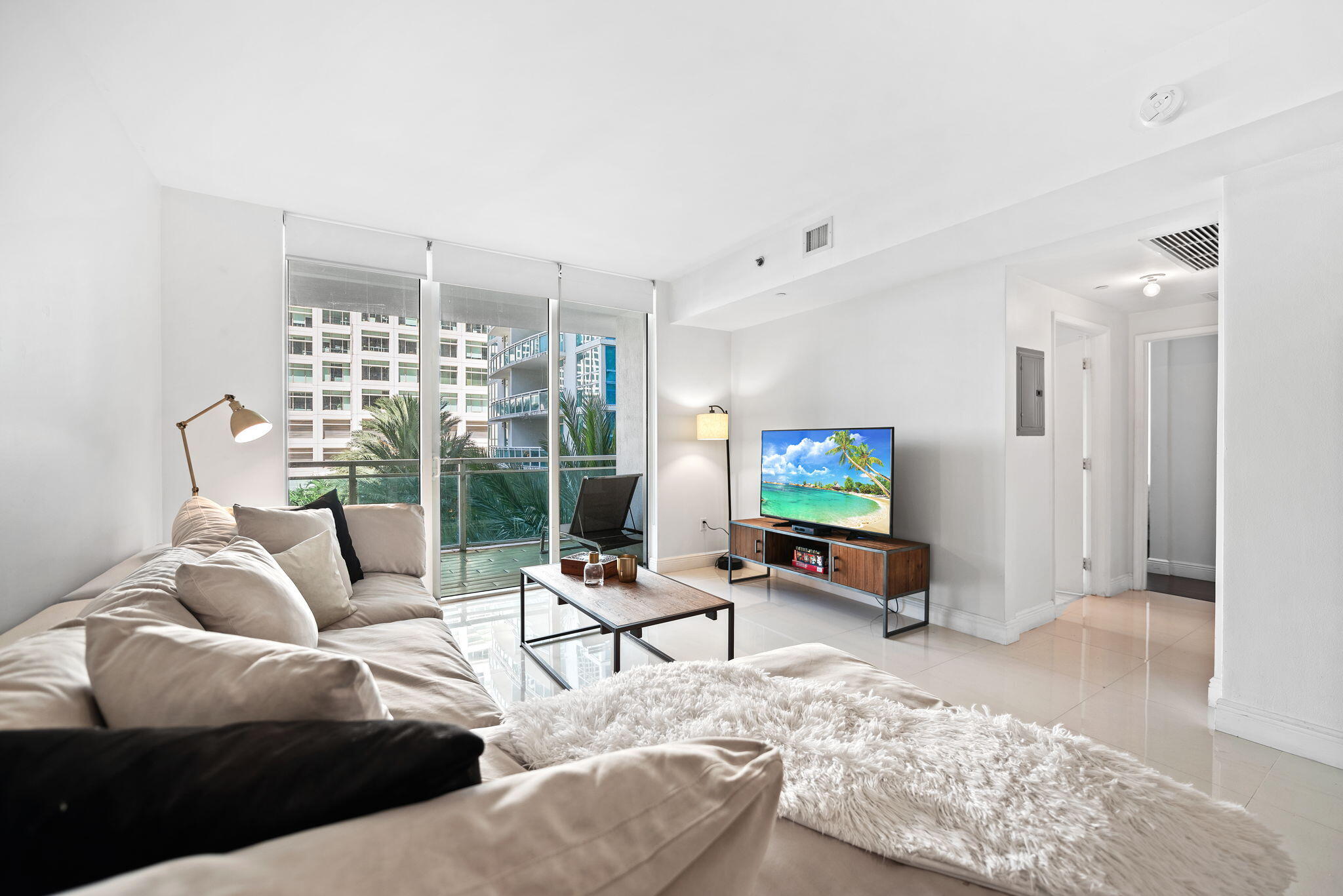 951 Brickell Avenue, Unit 400 Miami, FL 33131 - Photo 18 of 40 a living room with furniture and a flat screen tv