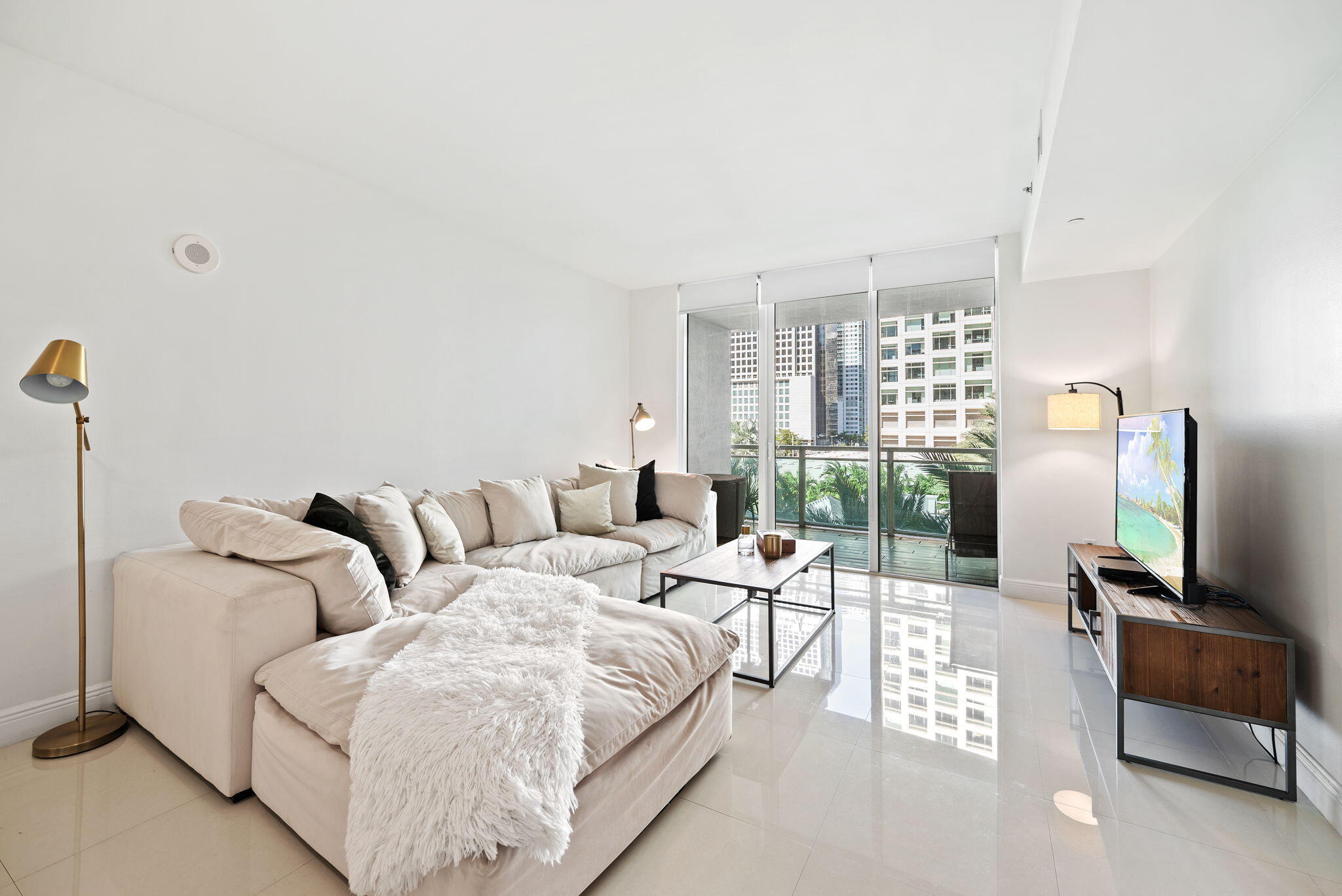 951 Brickell Avenue, Unit 400 Miami, FL 33131 - Photo 19 of 40 a living room with furniture and a flat screen tv