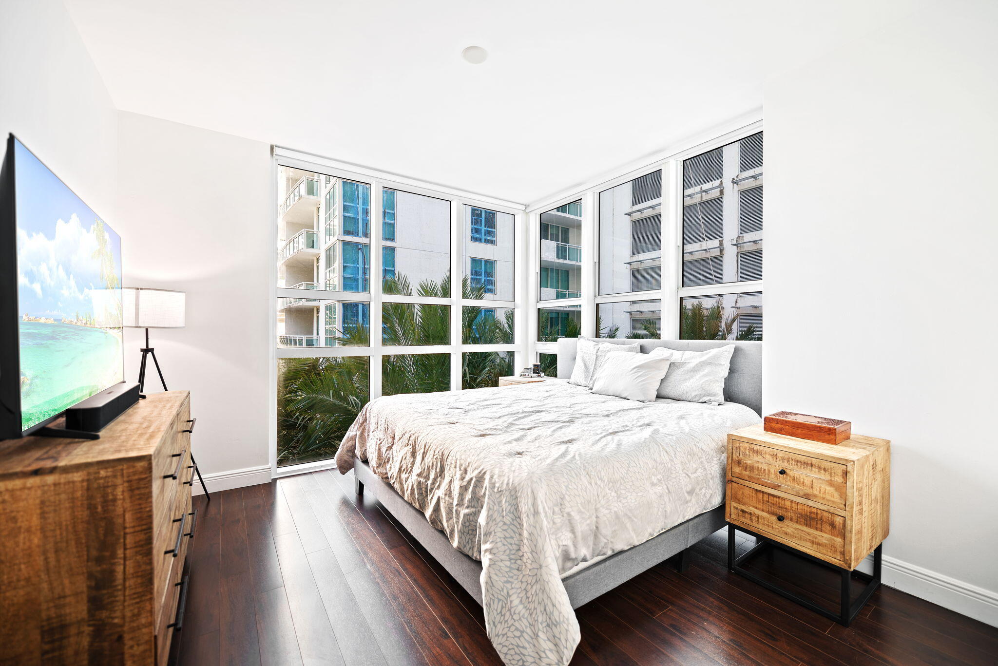951 Brickell Avenue, Unit 400 Miami, FL 33131 - Photo 20 of 40 a bedroom with a bed and a flat tv screen on the dresser