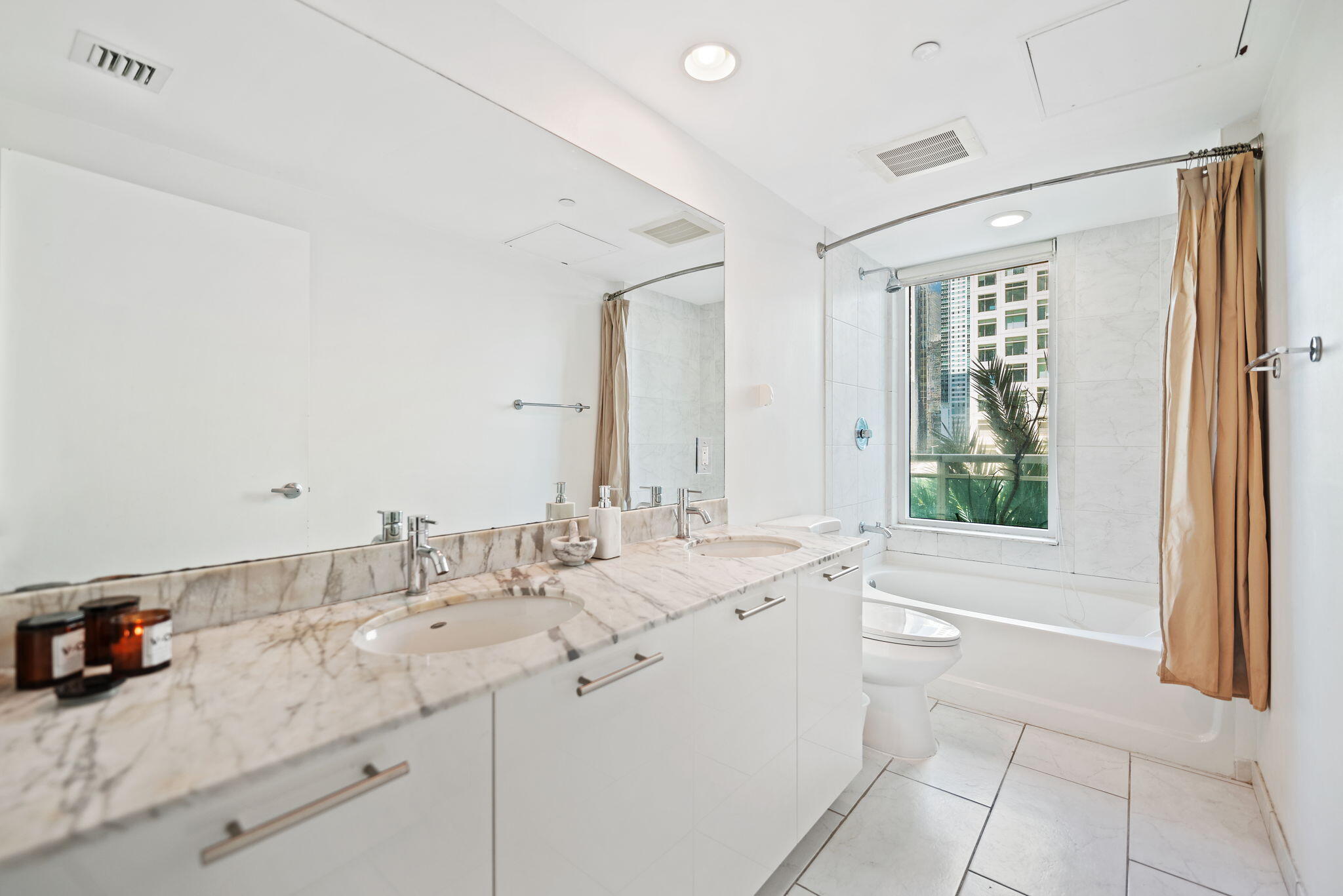 951 Brickell Avenue, Unit 400 Miami, FL 33131 - Photo 23 of 40 a bathroom with a double vanity sink mirror and bathtub