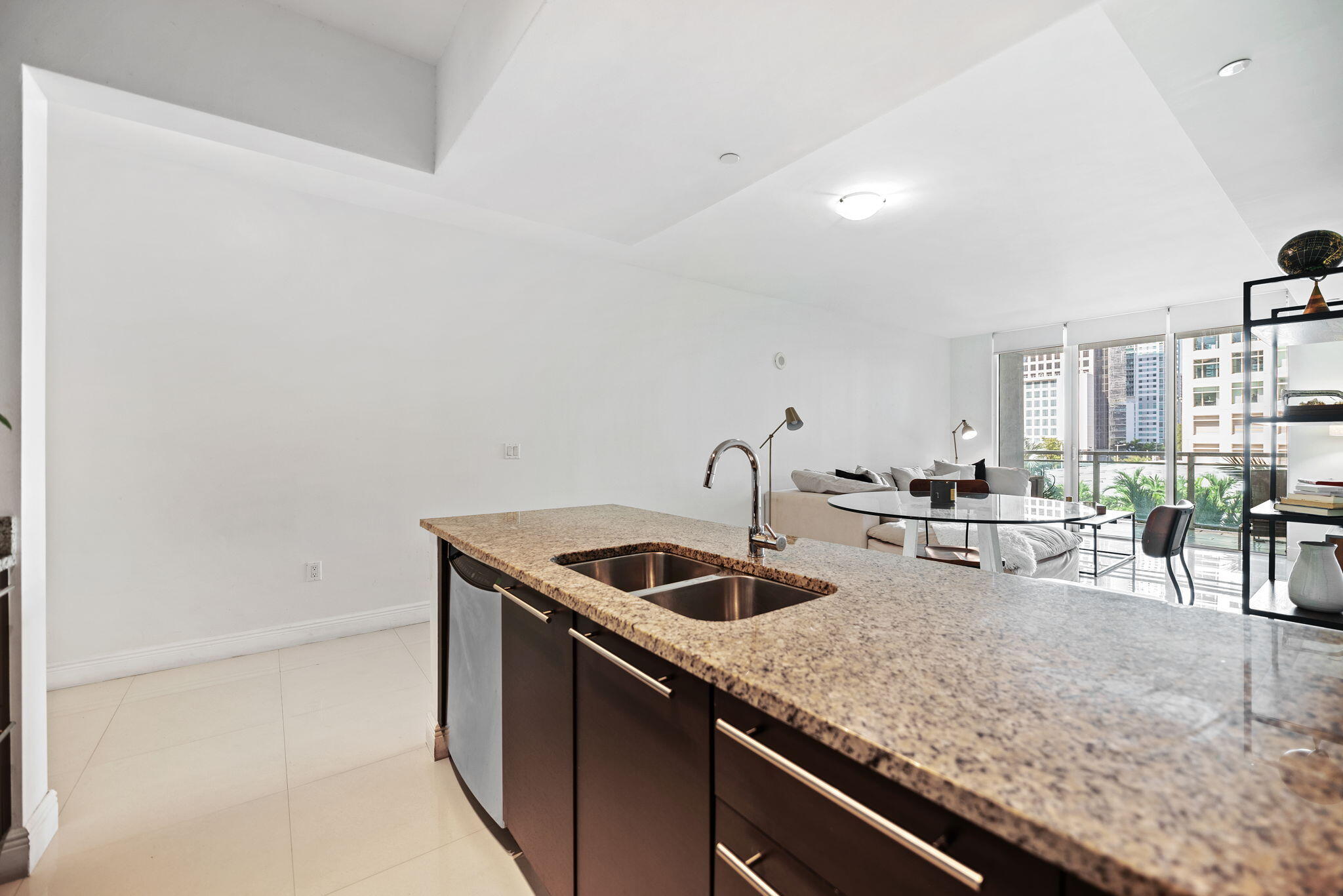 951 Brickell Avenue, Unit 400 Miami, FL 33131 - Photo 9 of 40 a kitchen with a sink and cabinets