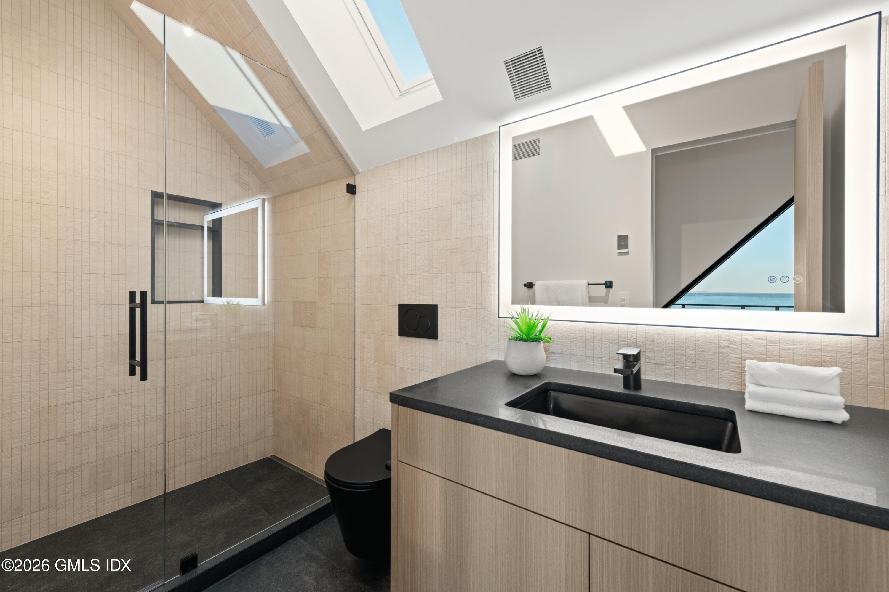 58 Shore Road Old Greenwich, CT 06870 - Photo 63 of 86 a bathroom with a sink and a mirror