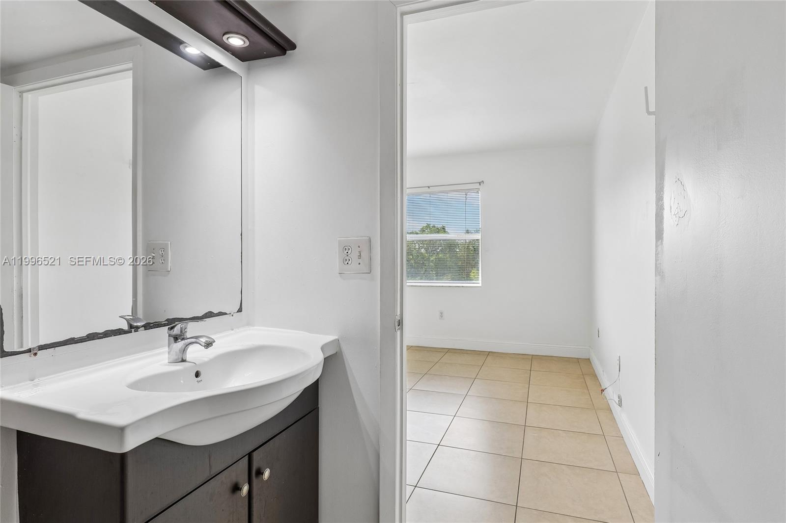 4137 Stirling Road, Unit 507 Dania Beach, FL 33314 - Photo 13 of 20 a bathroom with a sink and a mirror