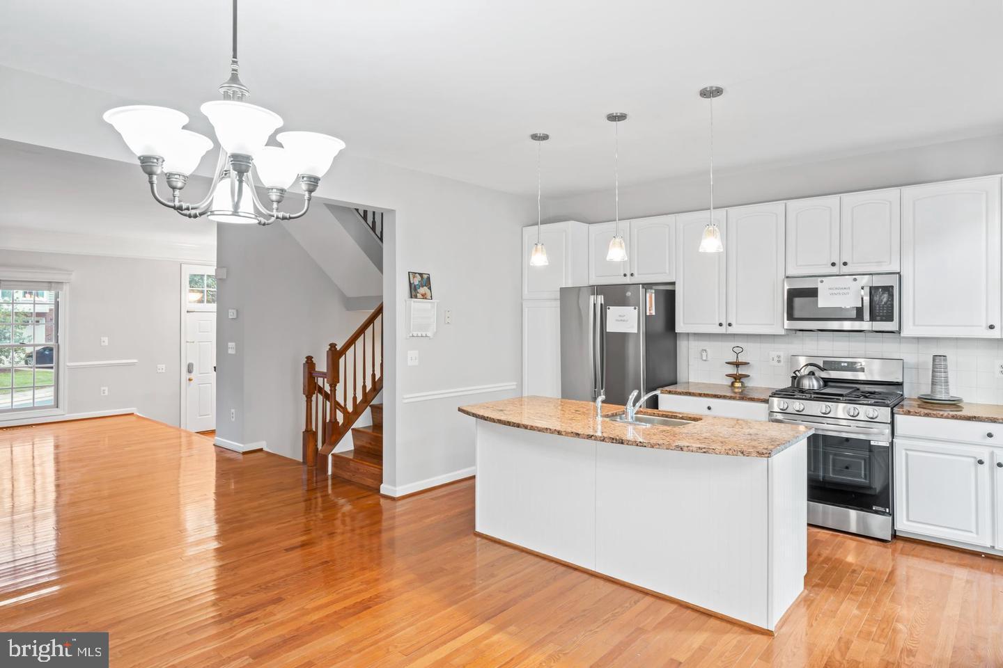 19893 Upland Terrace Ashburn, VA 20147 - Photo 13 of 29 a view of kitchen with stainless steel appliances granite countertop stove top oven and chandelier
