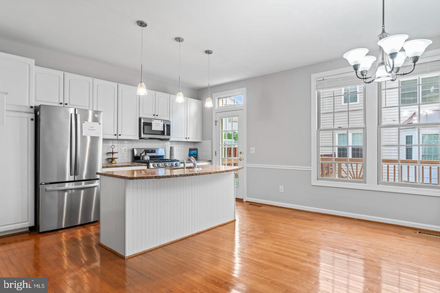 19893 Upland Terrace Ashburn, VA 20147 - Photo 14 of 29 a kitchen with stainless steel appliances granite countertop a refrigerator a stove a sink dishwasher and a refrigerator with wooden floor
