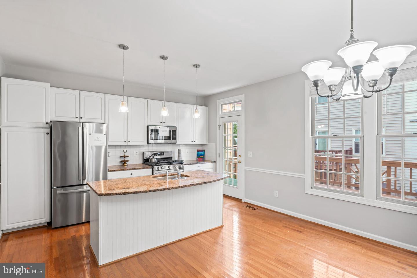19893 Upland Terrace Ashburn, VA 20147 - Photo 15 of 29 a kitchen with stainless steel appliances granite countertop a refrigerator a sink dishwasher a stove and white cabinets with wooden floor