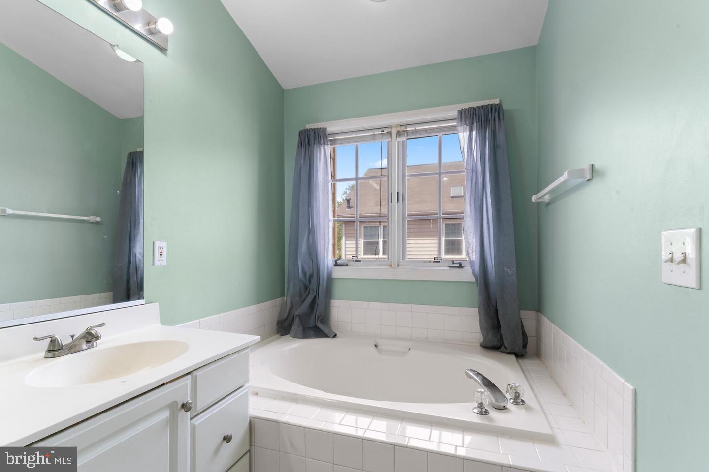 19893 Upland Terrace Ashburn, VA 20147 - Photo 18 of 29 a bathroom with a tub sink and mirror
