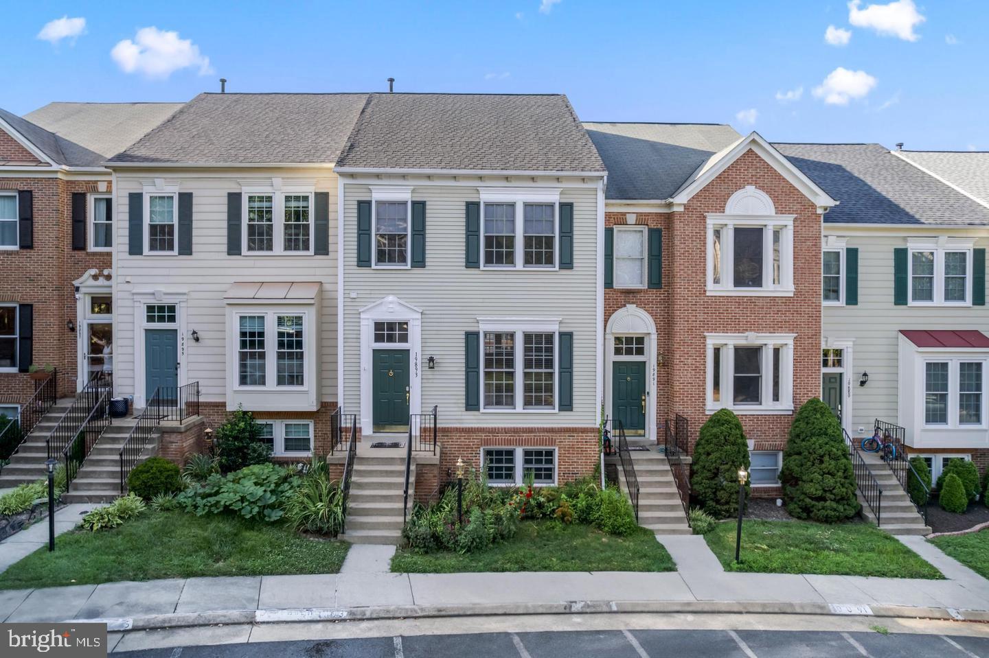 19893 Upland Terrace Ashburn, VA 20147 - Photo 2 of 29 a view of a brick house next to a yard