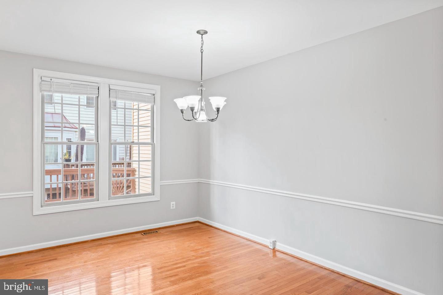 19893 Upland Terrace Ashburn, VA 20147 - Photo 9 of 29 a view of an empty room with chandelier and a window