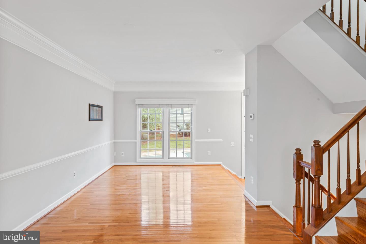 19893 Upland Terrace Ashburn, VA 20147 - Photo 10 of 29 a view of an empty room with wooden floor and a window