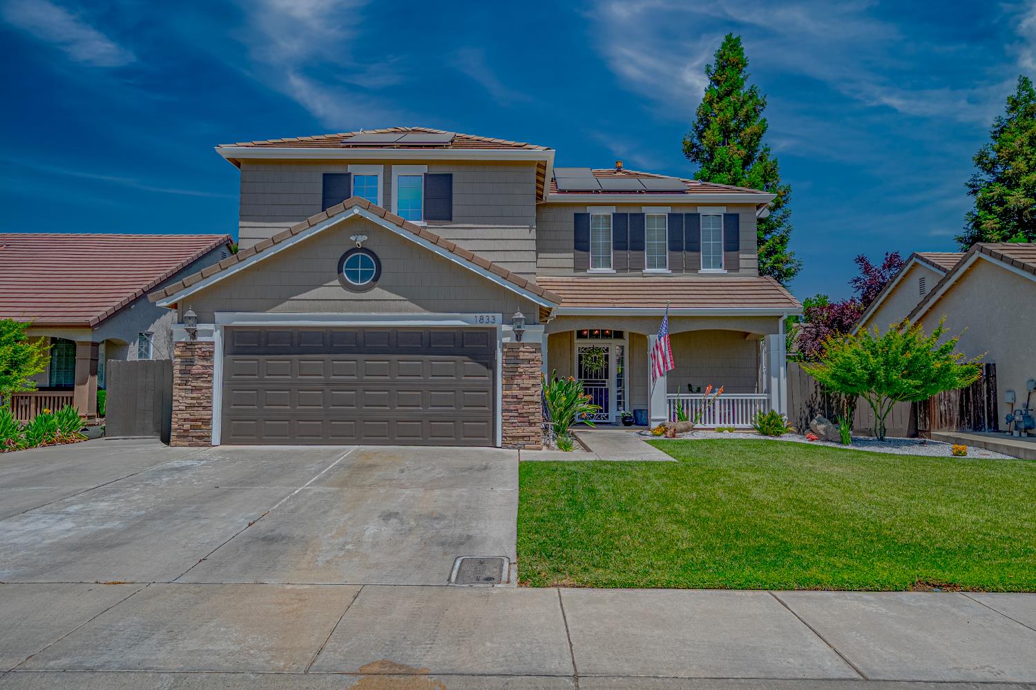 a front view of a house with a yard and garage