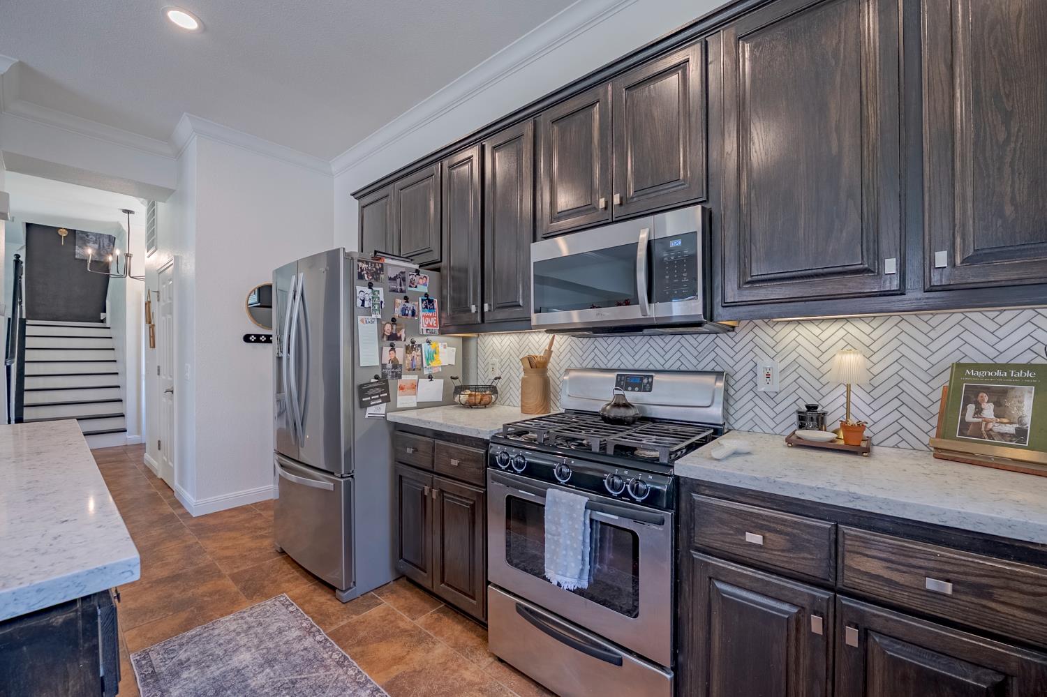 1833 La Quinta Court Merced, CA 95340 - Photo 28 of 55 a kitchen with stainless steel appliances granite countertop a stove a refrigerator and a microwave