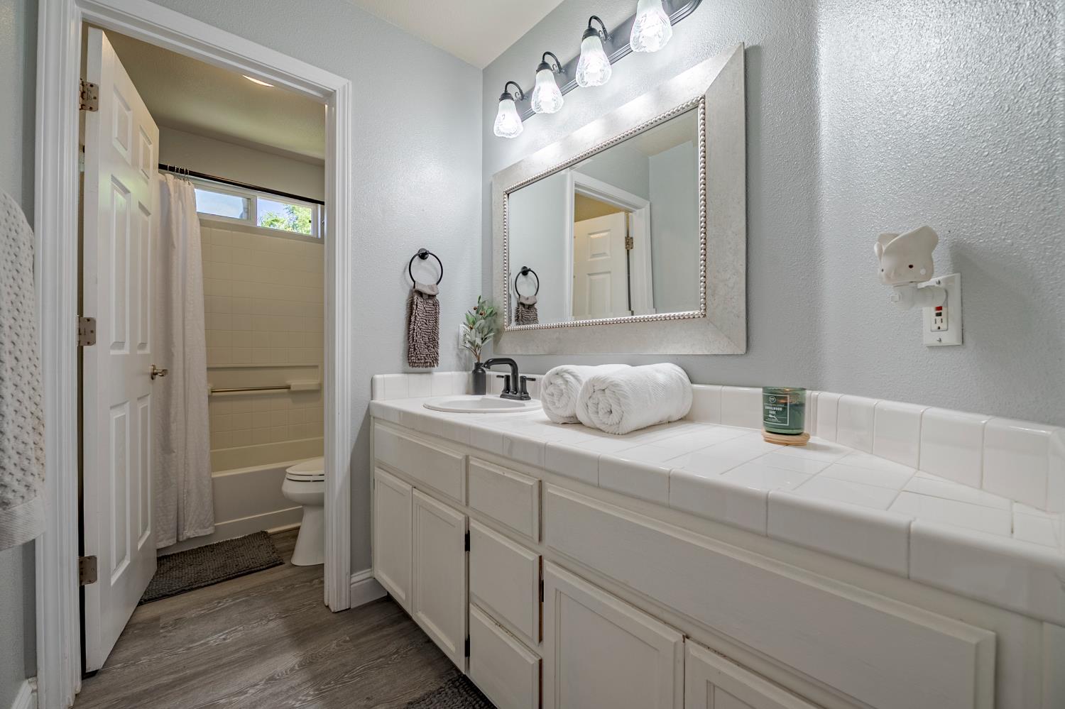 1833 La Quinta Court Merced, CA 95340 - Photo 34 of 55 a bathroom with a double vanity sink and a mirror