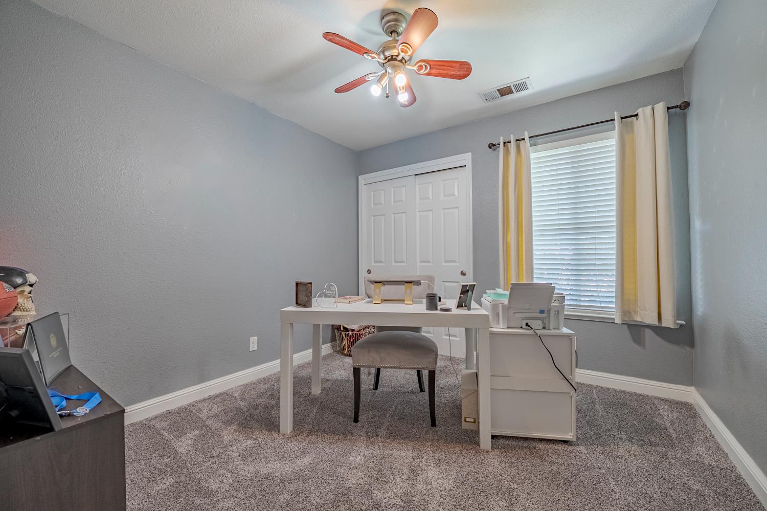 1833 La Quinta Court Merced, CA 95340 - Photo 35 of 55 a view of a workspace with furniture and a window