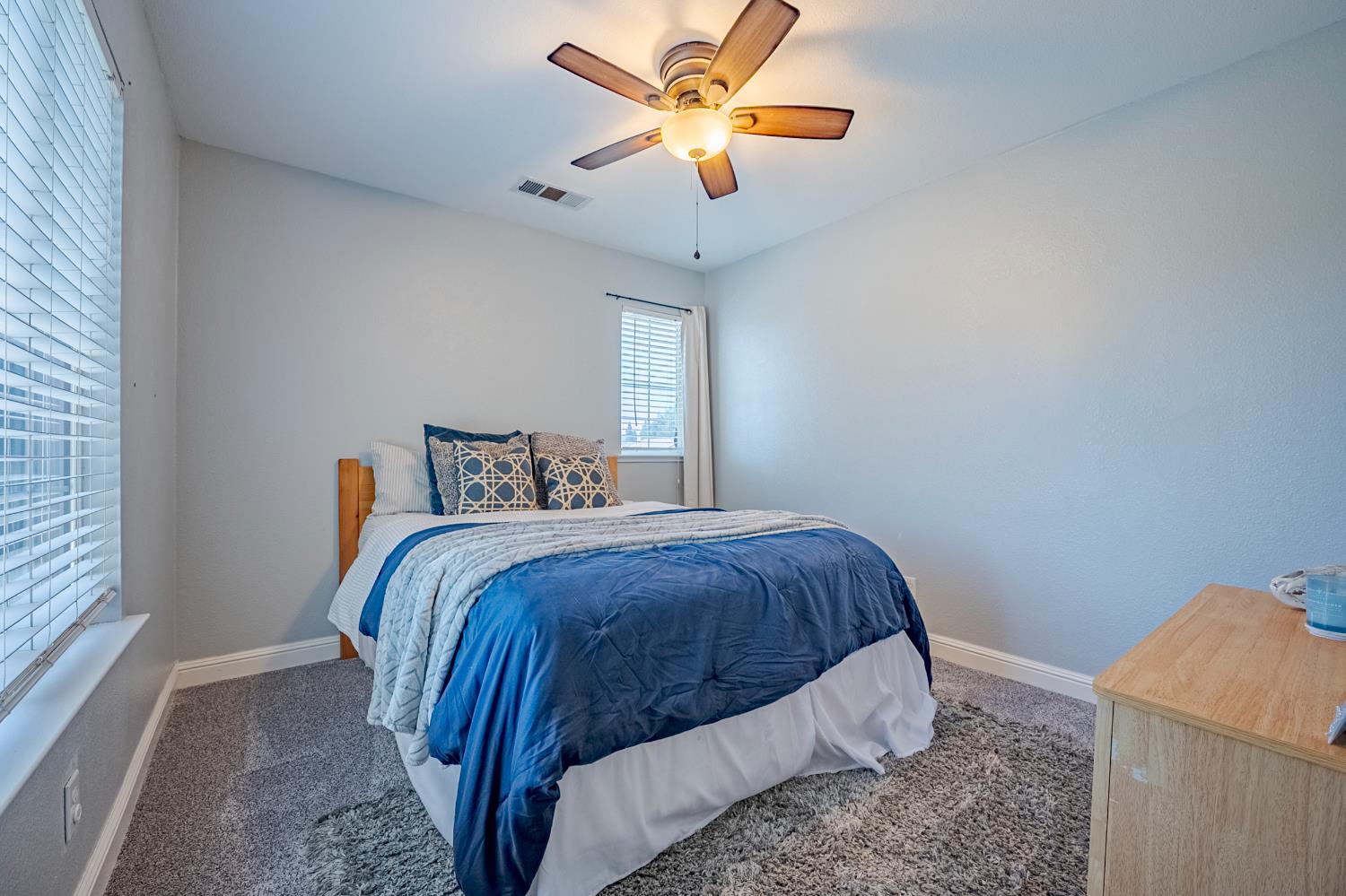 1833 La Quinta Court Merced, CA 95340 - Photo 37 of 55 a bedroom with a bed and a chandelier