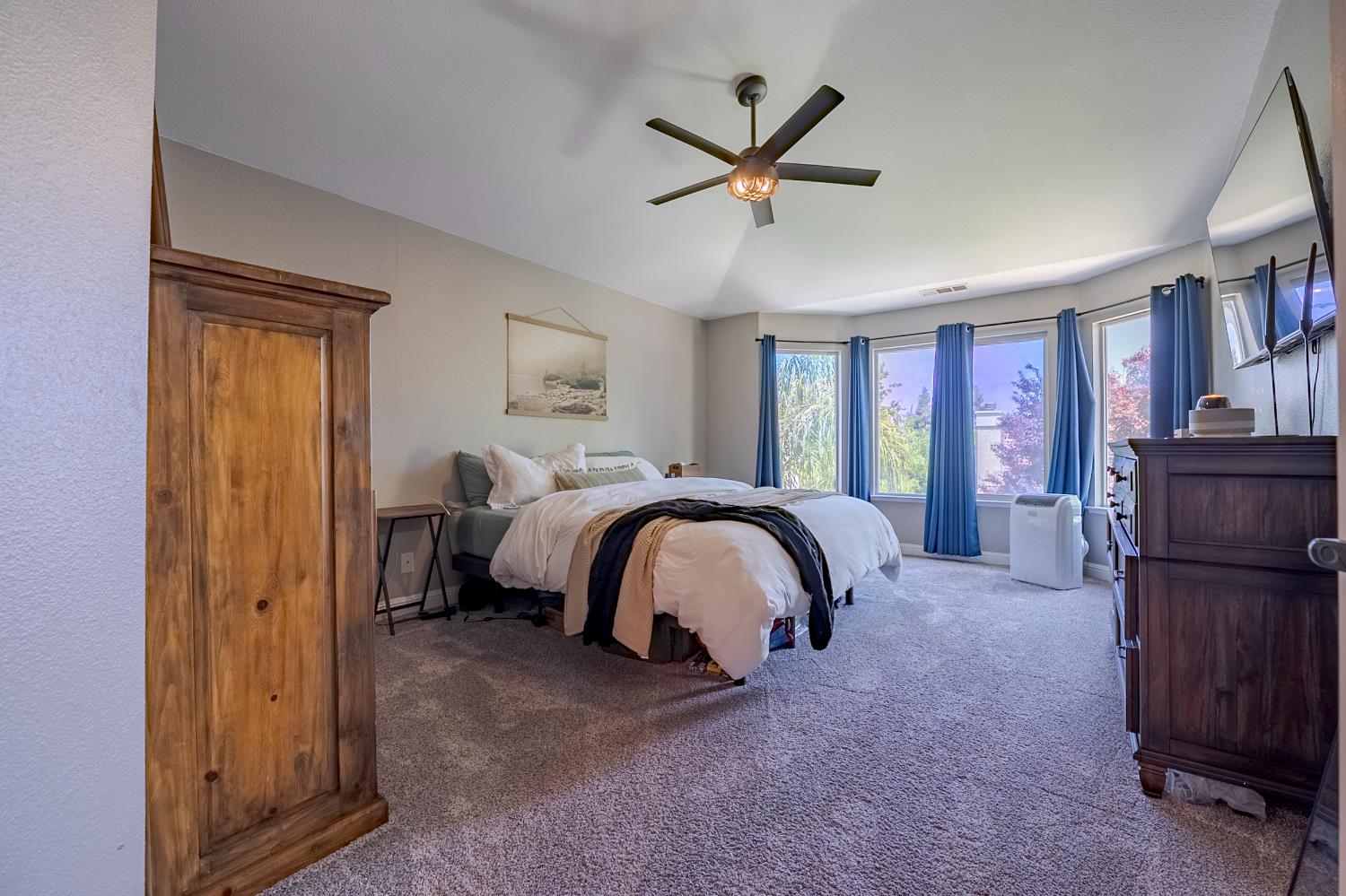 1833 La Quinta Court Merced, CA 95340 - Photo 40 of 55 a spacious bedroom with a bed a dresser and book shelfs