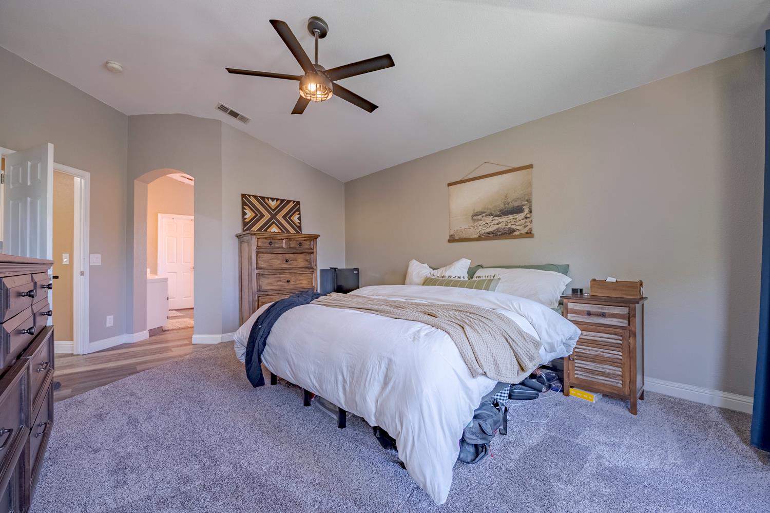 1833 La Quinta Court Merced, CA 95340 - Photo 42 of 55 a bedroom with a bed a chandelier and a window