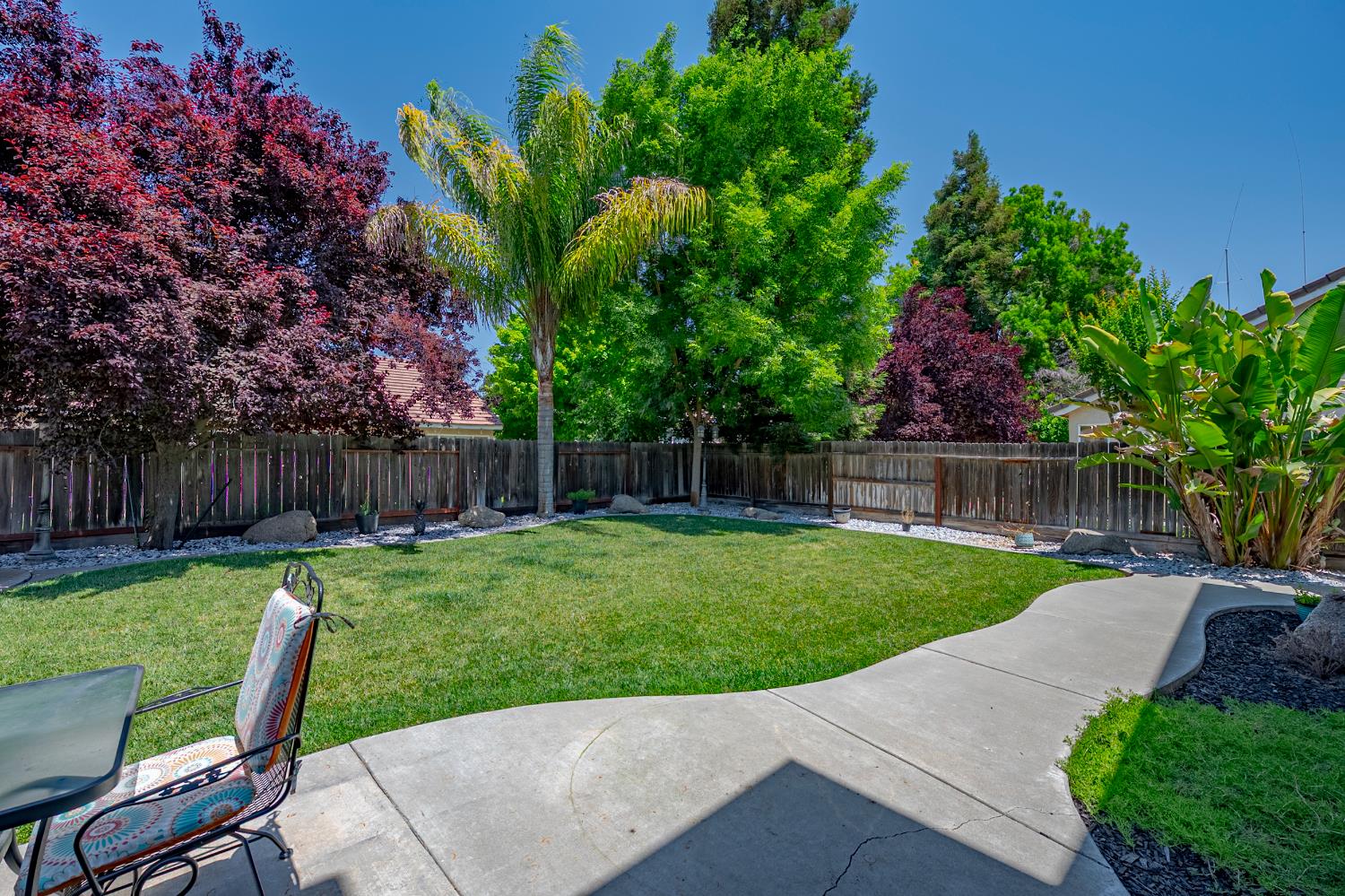 1833 La Quinta Court Merced, CA 95340 - Photo 45 of 55 a view of backyard with wooden fence and a large tree