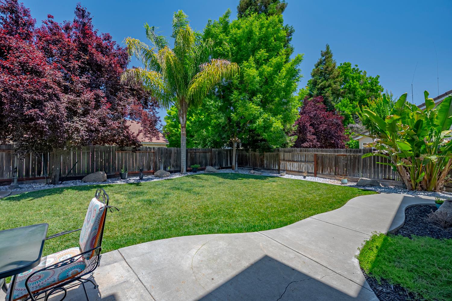 1833 La Quinta Court Merced, CA 95340 - Photo 47 of 55 a view of backyard with wooden fence and a large tree