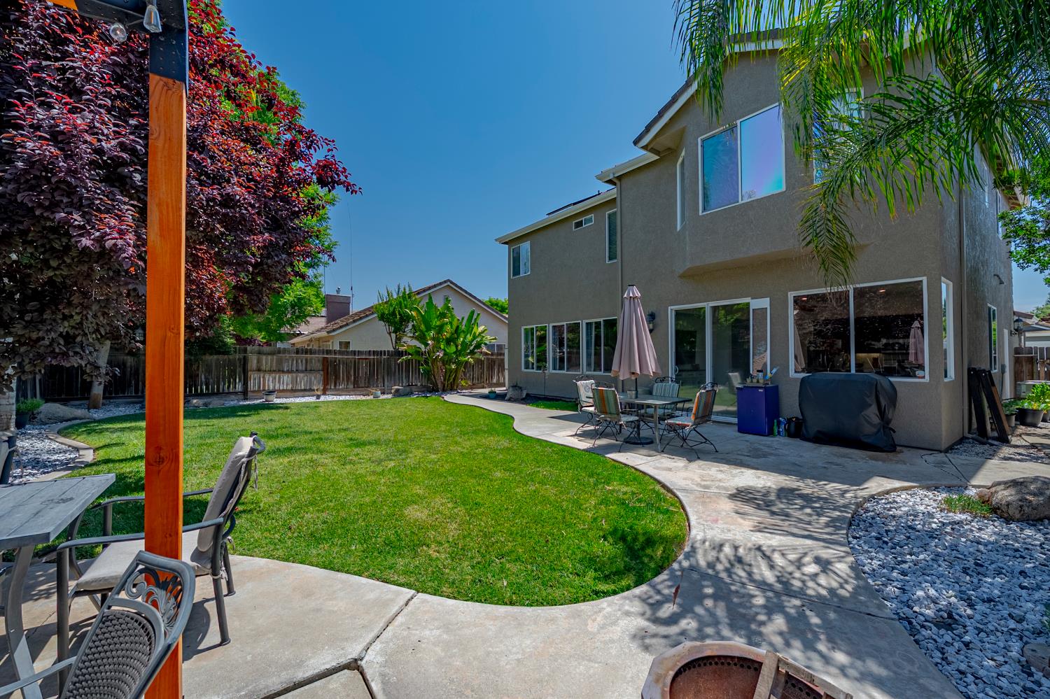 1833 La Quinta Court Merced, CA 95340 - Photo 50 of 55 a view of a backyard with table and chairs potted plants and palm tree