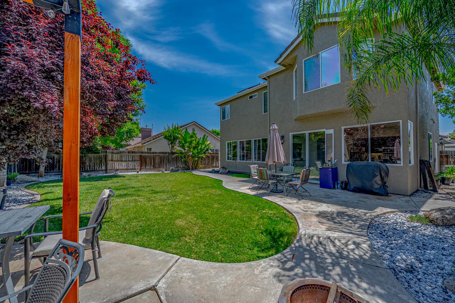 1833 La Quinta Court Merced, CA 95340 - Photo 51 of 55 a view of a backyard with table and chairs potted plants and palm tree
