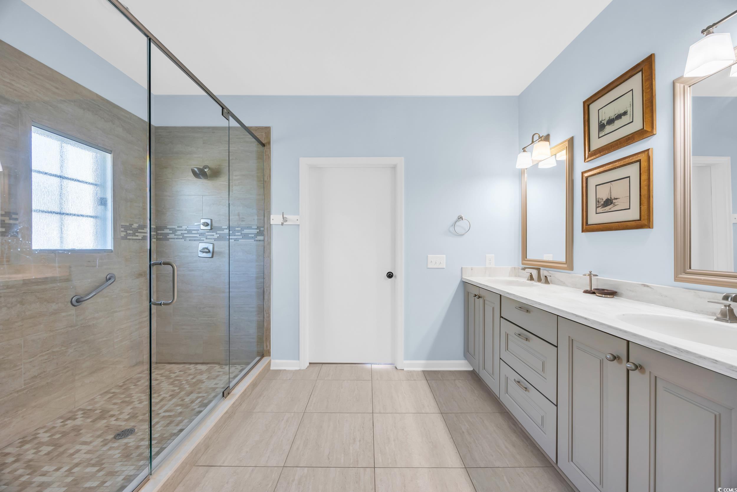 471 Norris Drive Pawleys Island, SC 29585 - Photo 20 of 40 Full bathroom featuring double vanity, a stall shower, and light tile patterned floors