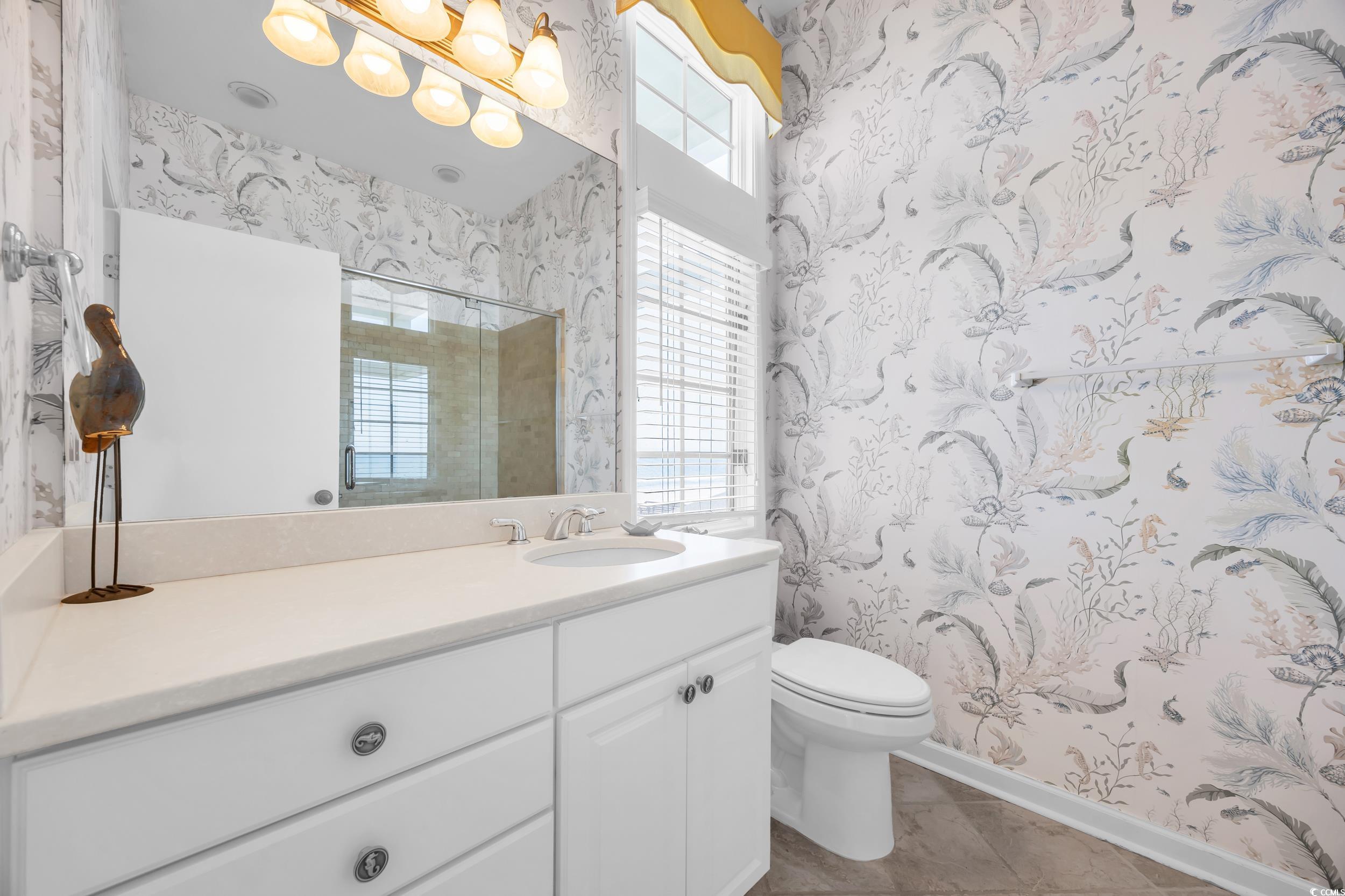 471 Norris Drive Pawleys Island, SC 29585 - Photo 27 of 40 Full bathroom featuring wallpapered walls, vanity, a stall shower, and light tile patterned flooring