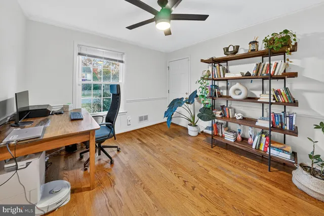 a workspace with furniture and wooden floor