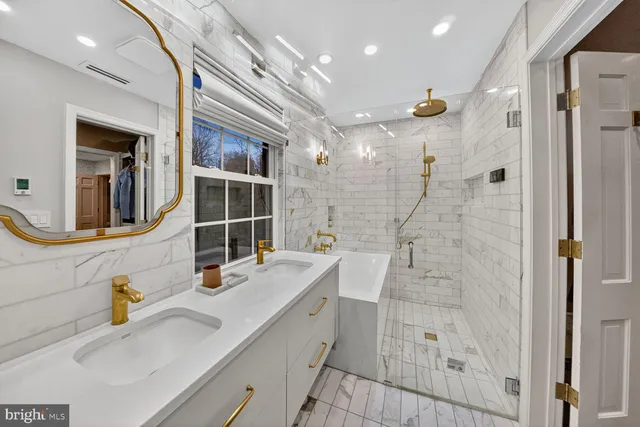 a bathroom with a granite countertop sink a mirror and shower