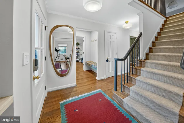 a view of an entryway with wooden floor