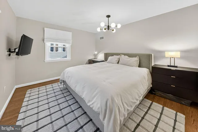 a bedroom with a bed and a night stand