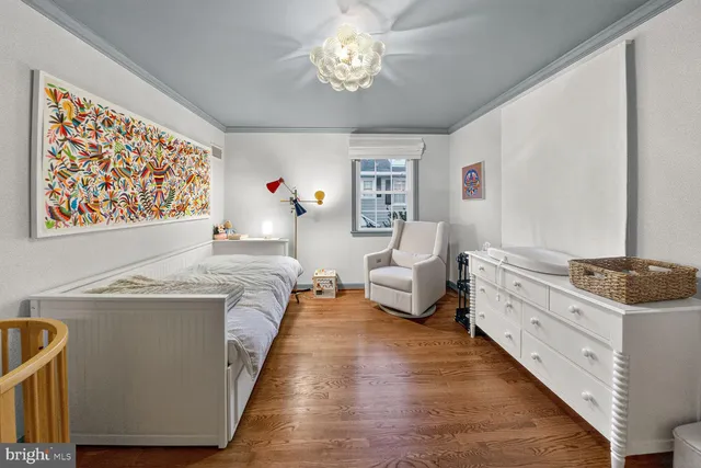 a spacious bedroom with a bed and a chandelier