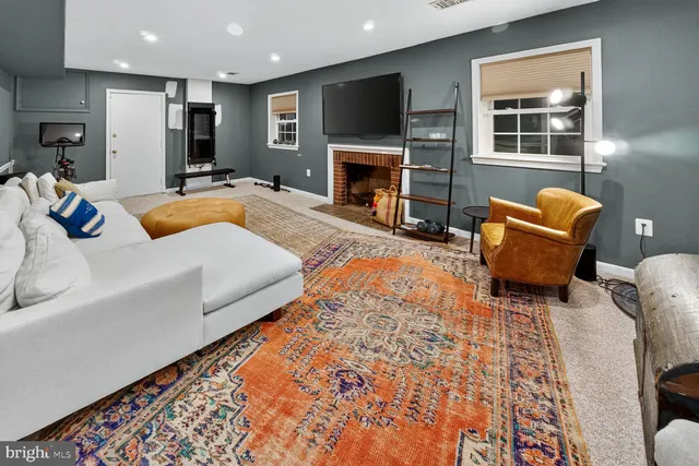 a living room with furniture fireplace and flat screen tv