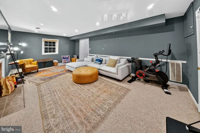 a bedroom with furniture and a gym equipment