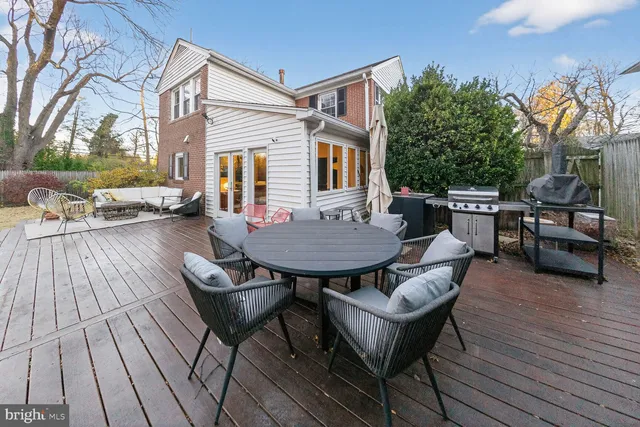a backyard of a house with barbeque oven table and chairs