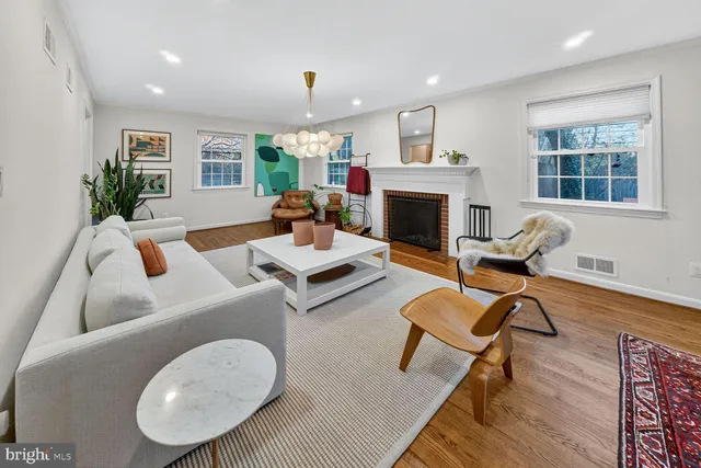 a living room with furniture a fireplace and window