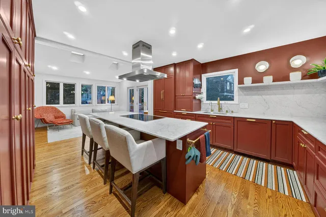 a large kitchen with a table and chairs