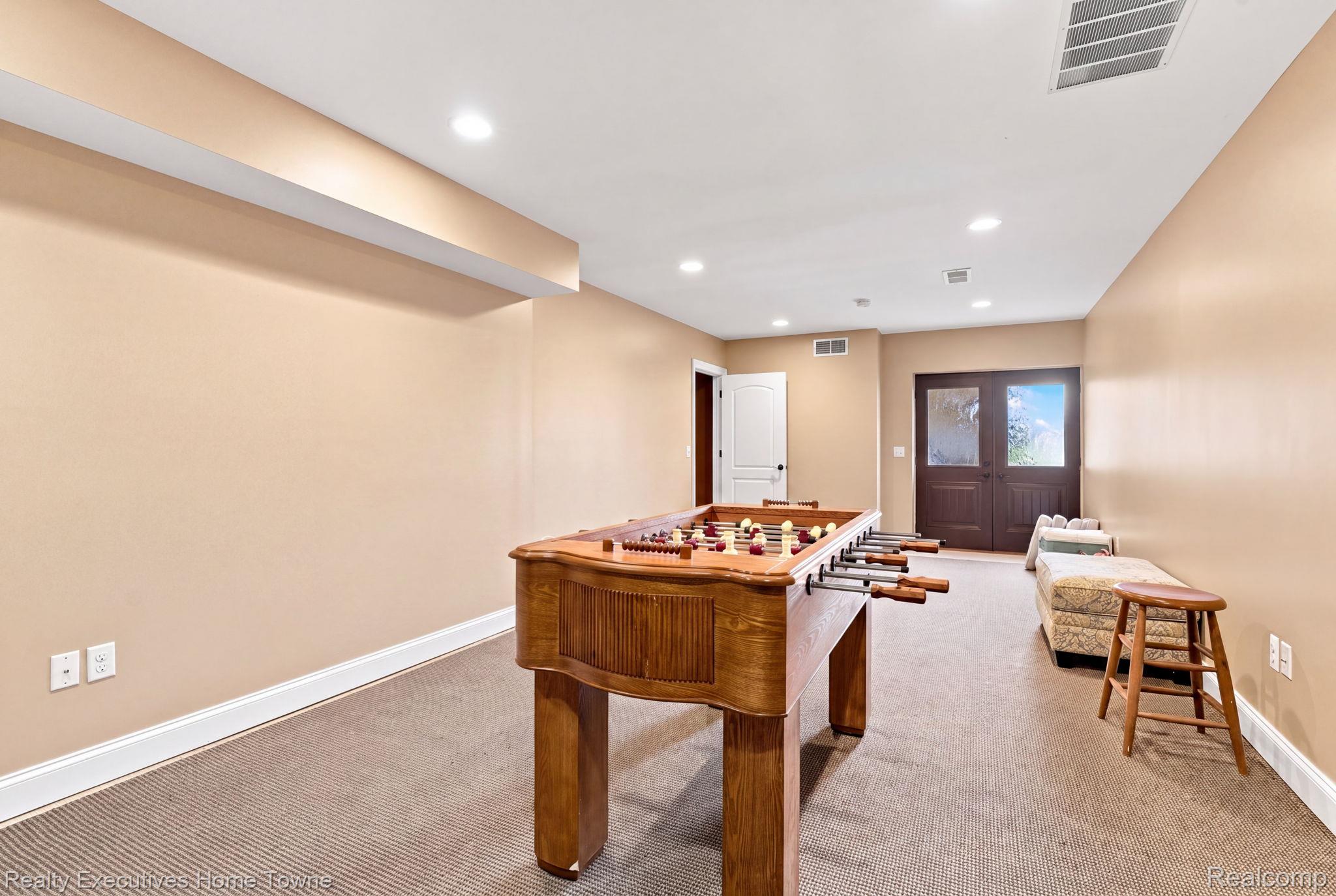 2829 Riverside Drive Port Huron, MI 48060 - Photo 56 of 99 Recessed lighting, carpeted flooring, light-toned walls, white trim, and dark wood double doors